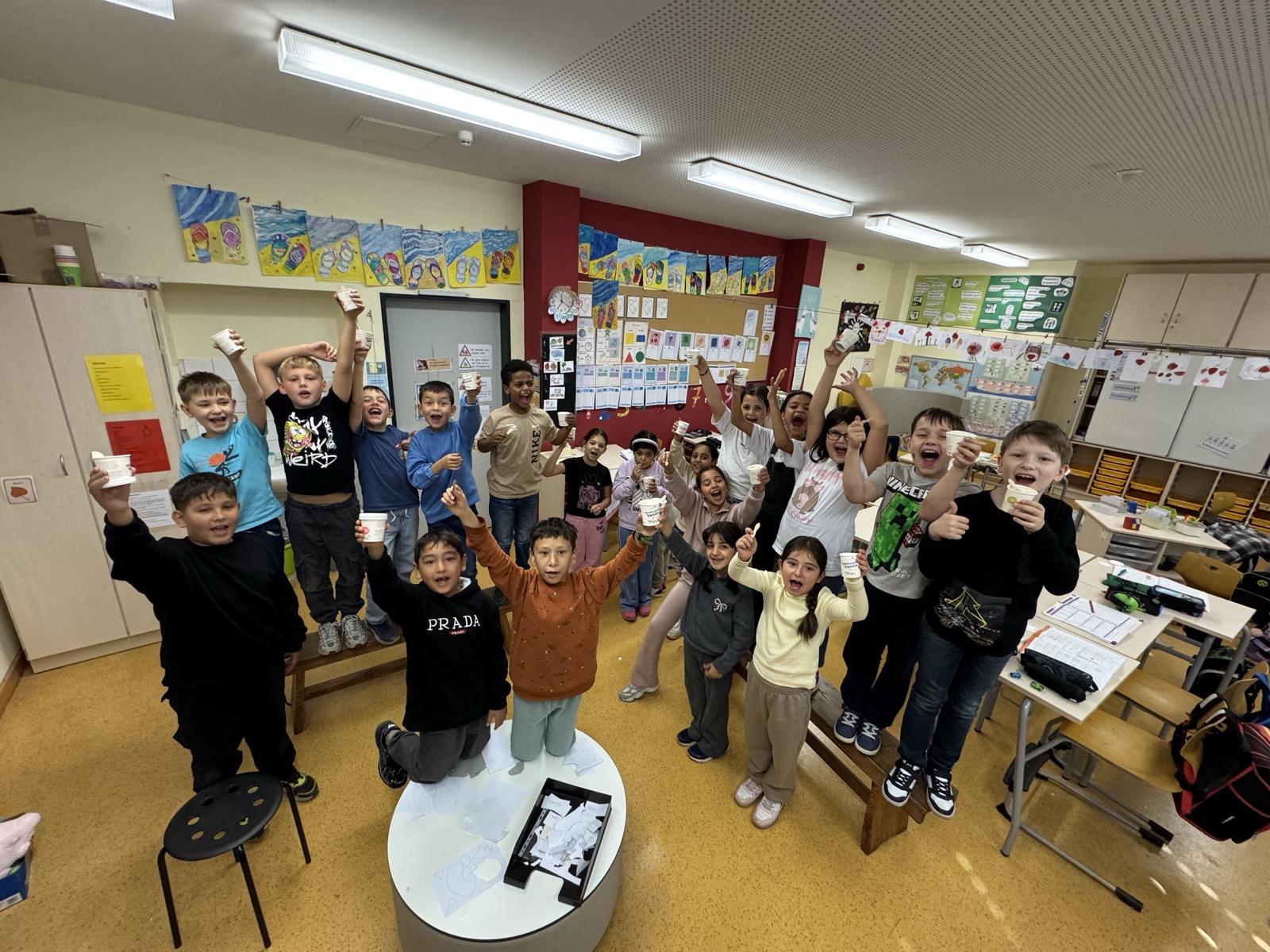 Jubelnde Schulklasse im Klassenraum